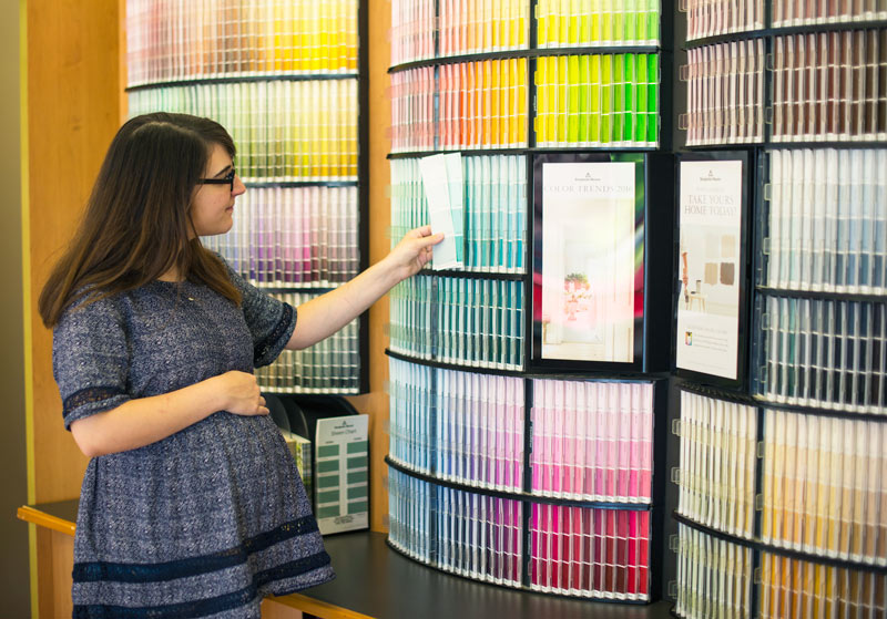 Benjamin Moore Paint Store Client Looking at Paint Colors Swatches